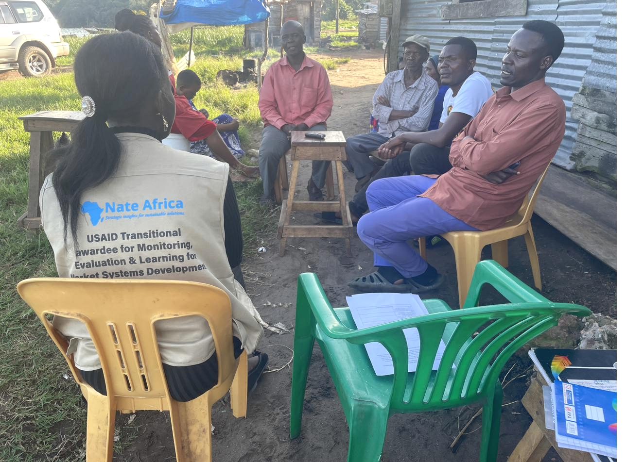 A Nate Africa Consulting field session with participants seated under shade during a WASH assessment in Kalangala