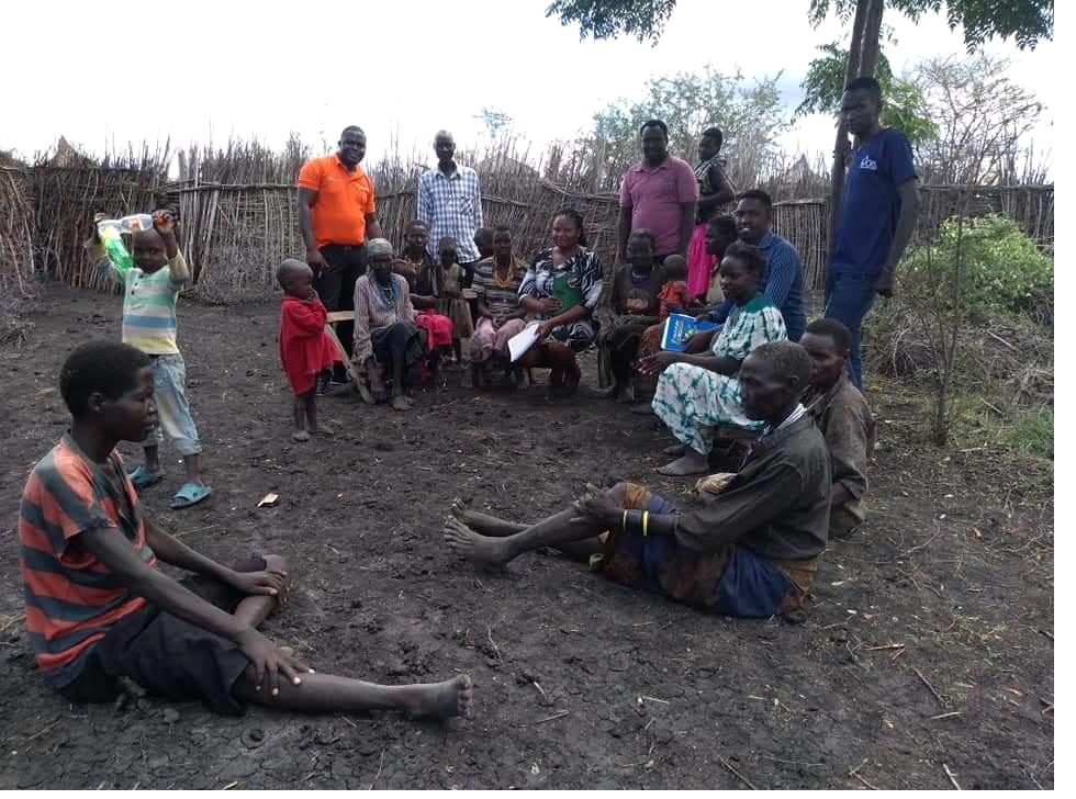 Community members seated on the ground during a supervised data collection session in Napak, Karamoja
