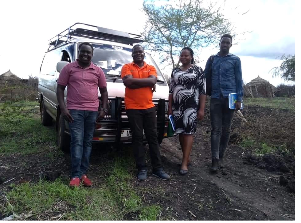 A research team assembled by their field vehicle before a data collection round in a remote district
